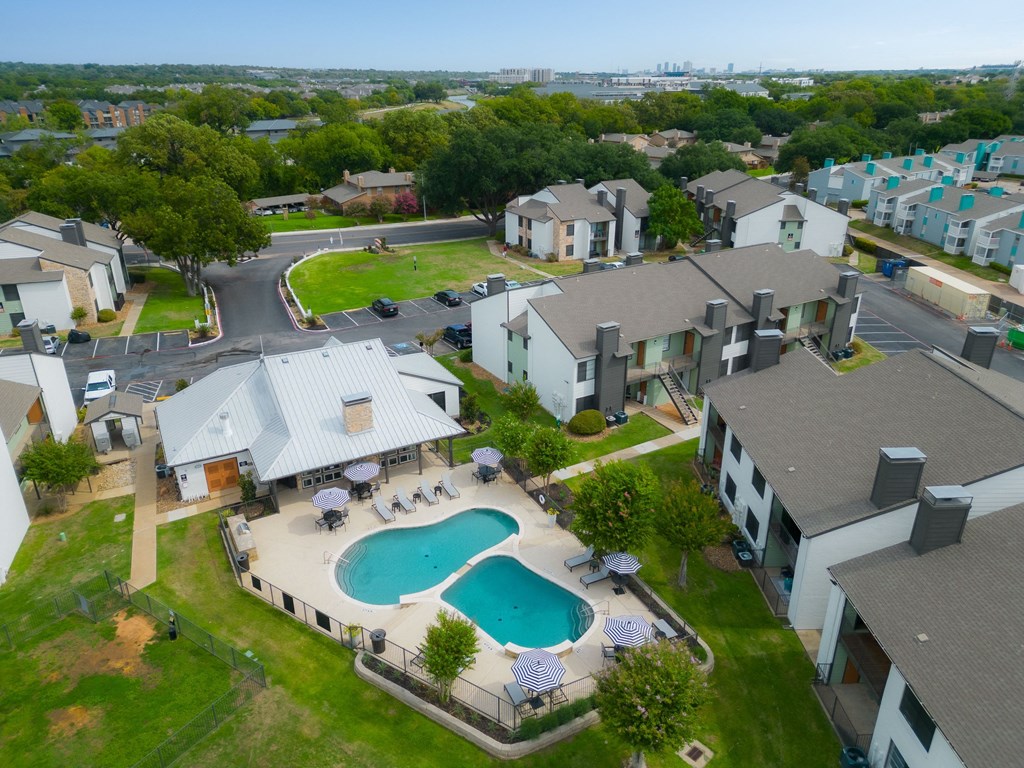 an aerial view of a house with a swimming pool in the middle of the yard