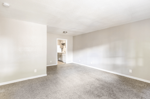 A spacious room with a carpeted floor and a doorway leading to another room. at Oaks at Spring Valley, Texas