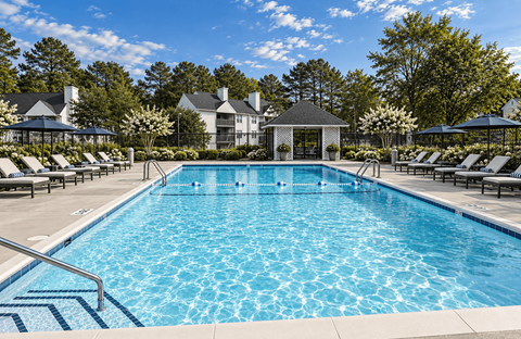 A large swimming pool with a gazebo in the background.