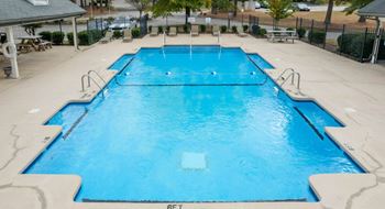 the pool is filled with blue water at the resort