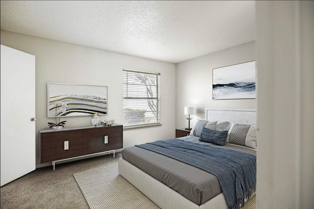 a bedroom with a bed and a dresser and a window