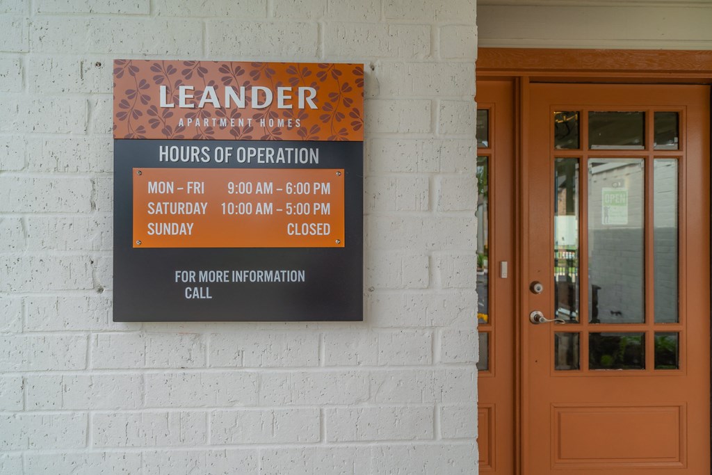 a sign on the side of a building saying landlord hours of operation