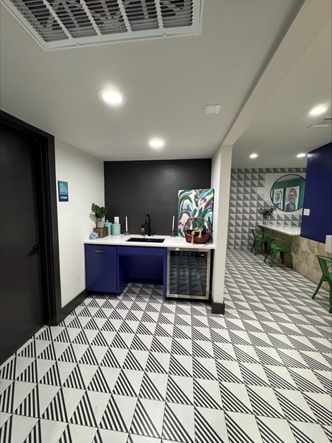 Community kitchenette with bold blue cabinetry at Lumina Apartments, Dallas, TX 75240