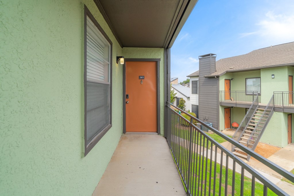 an empty room with benches and an orange door