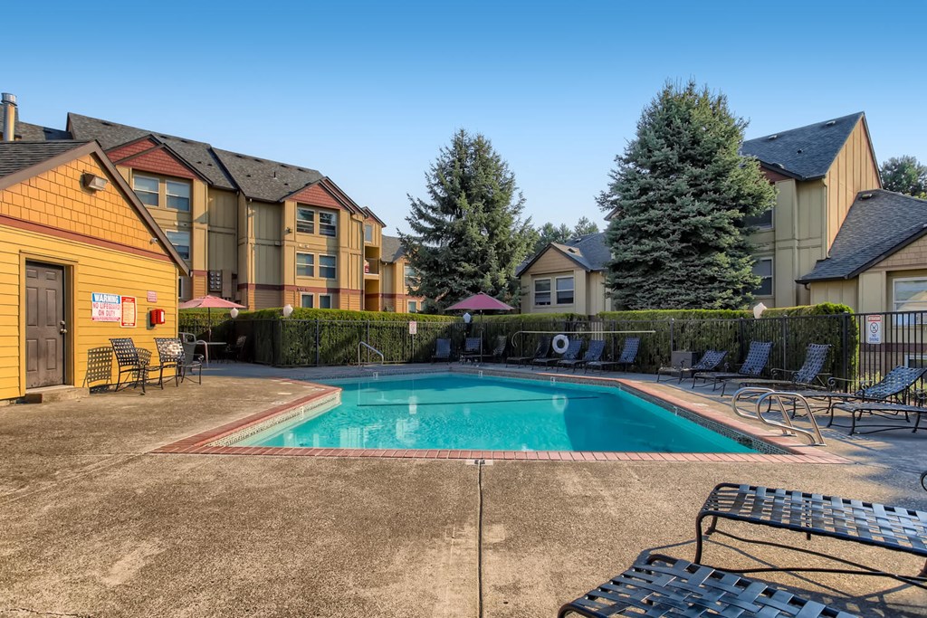 Happy Valley Apartments For Rent - Gated Pool With A Hot Tub. Plenty Of Lounge Chairs, Patio Table With Umbrella, And Maintain Landscaping.