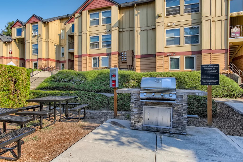 our apartments have a picnic area with a grill and tables
