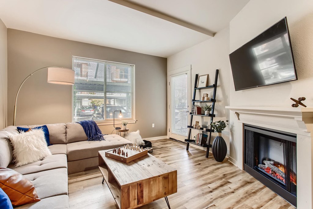 Fairview OR Apartments - Lodges at Lake Salish - Living Room with Hardwood-Style Flooring, Fireplace, Couch, Coffee Table, and High Ceilings