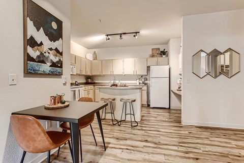 a kitchen and dining area with a table and chairs