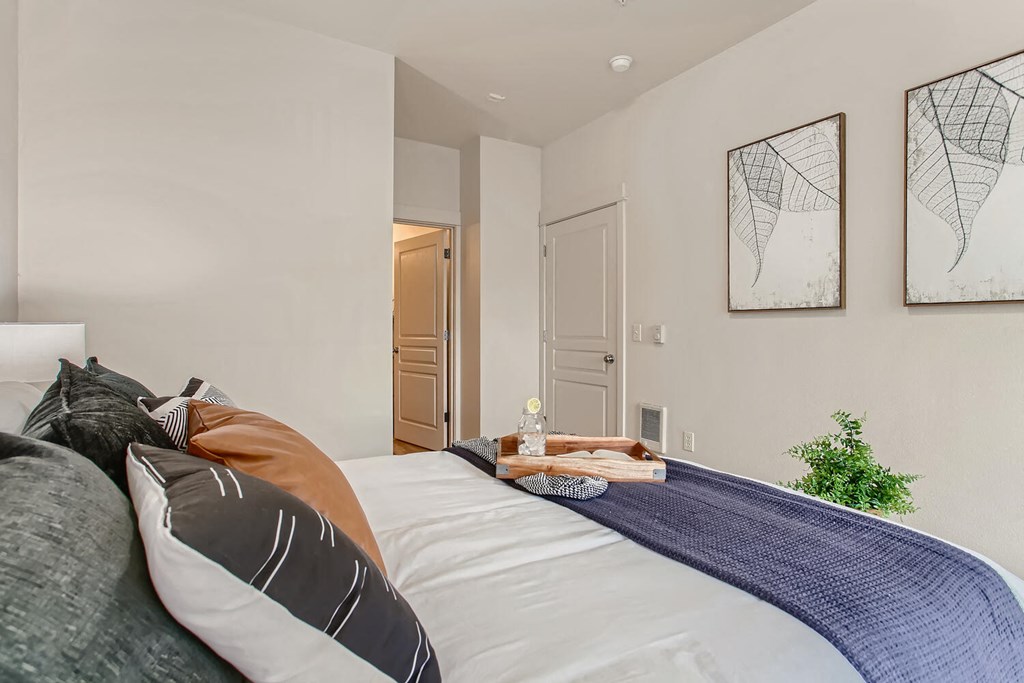 a bedroom with a large bed and a door to a bathroom