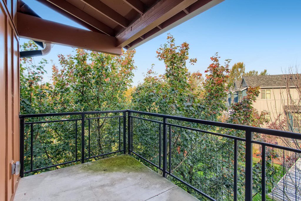 Apartments for Rent in Fairview - Lodges at Lake Salish - Large Covered Patio with Metal Railing and Gorgeous Landscape Views