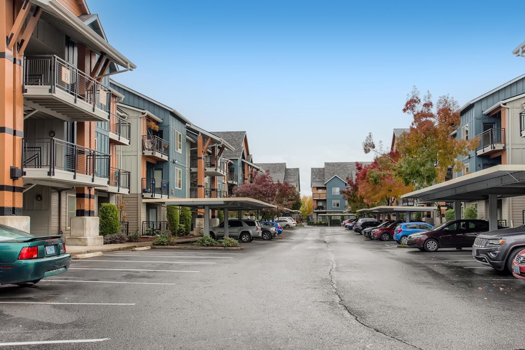 an empty parking lot in front of an apartment building