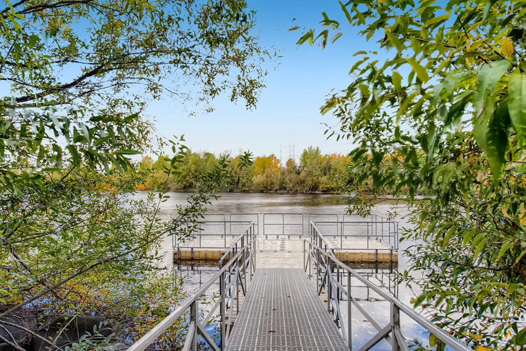 Apartments in Fairview for Rent - Serene Dock on the Lake Surrounded by Lush Trees.
