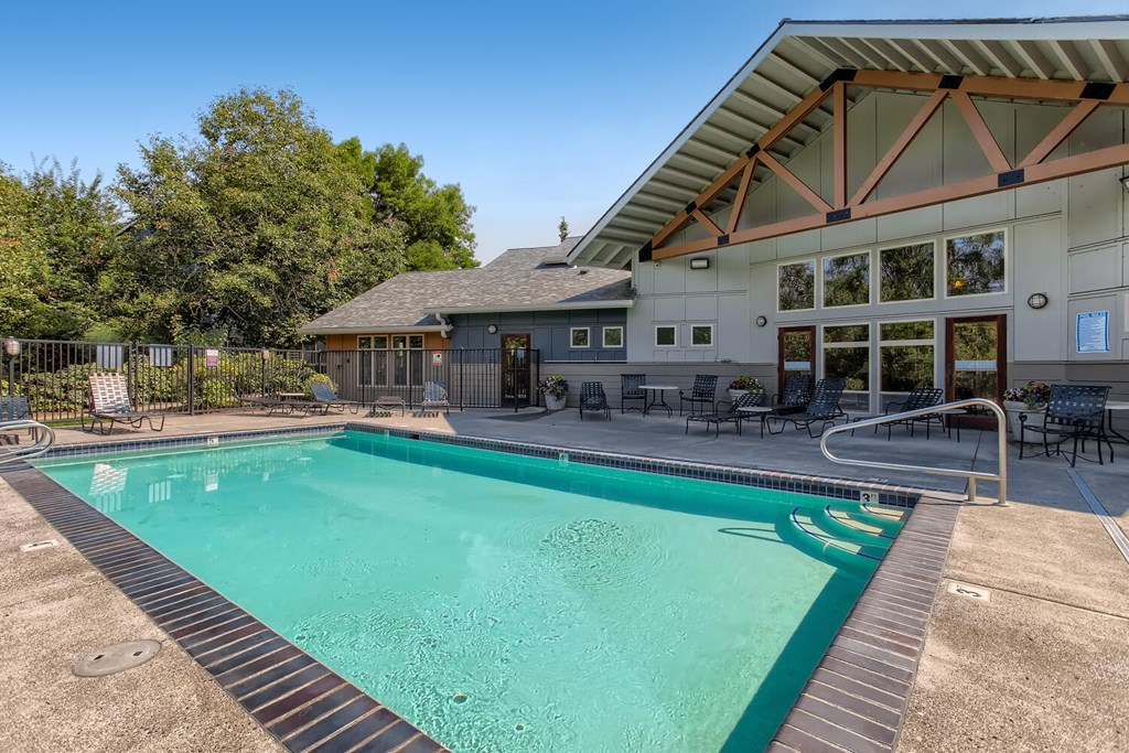 Fairview Apartments - Lodges at Lake Salish - Fenced-in Pool with Spa and Lush Trees