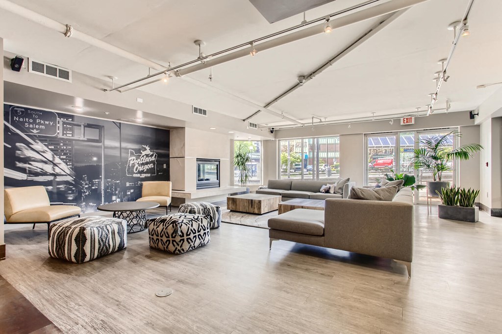 a lobby with couches and chairs and a chalkboard on the wall