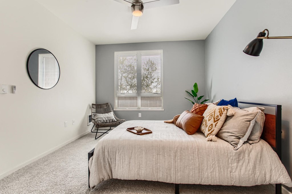 a bedroom with a bed and a window