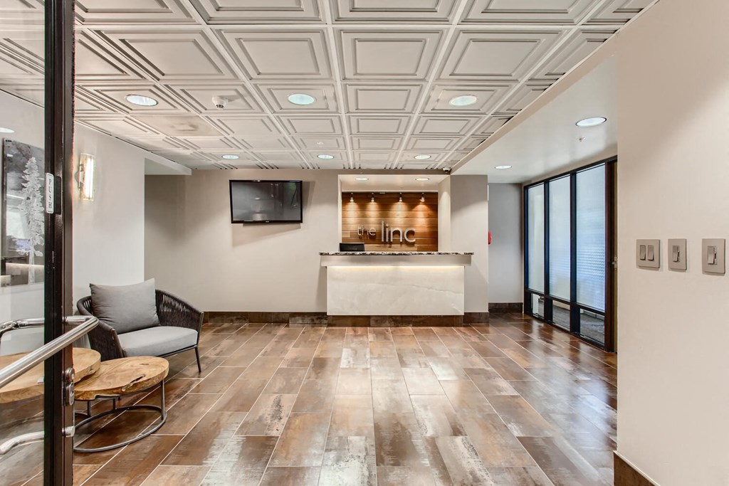 a lobby with a reception desk and a tv