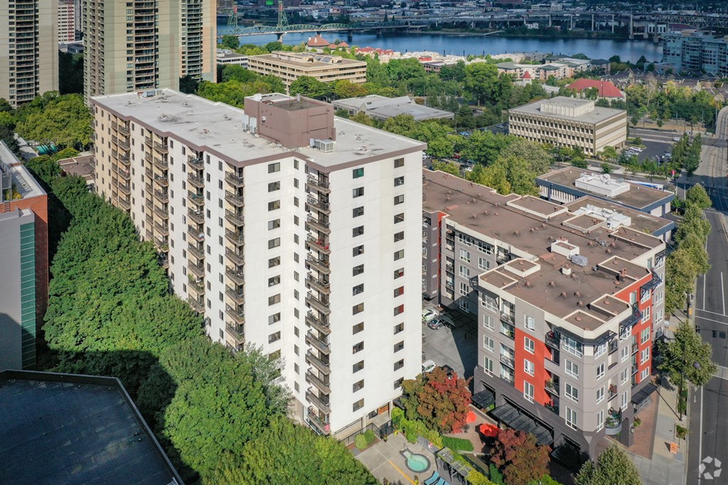 an aerial view of an apartment building with a river in the background