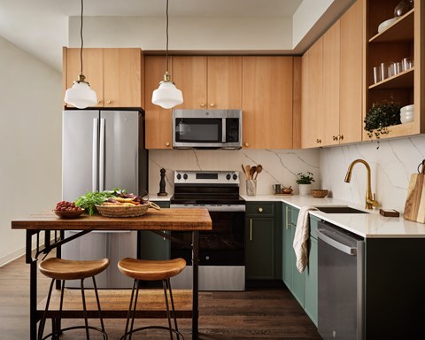 a kitchen with wooden cabinets and a table with three stools