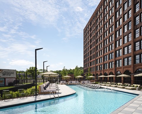 a swimming pool in front of a tall building