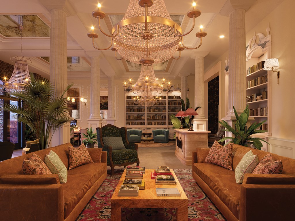 a living room with couches and chairs and a chandelier