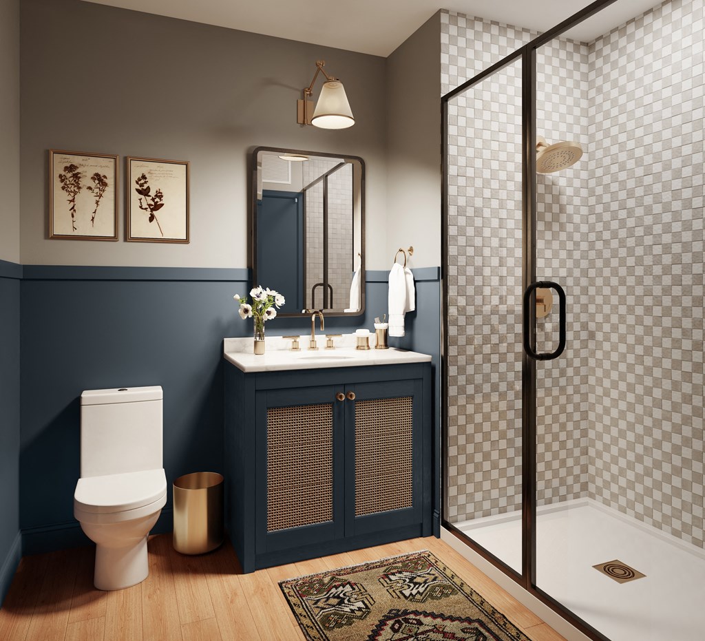 a bathroom with a toilet and a sink and a shower