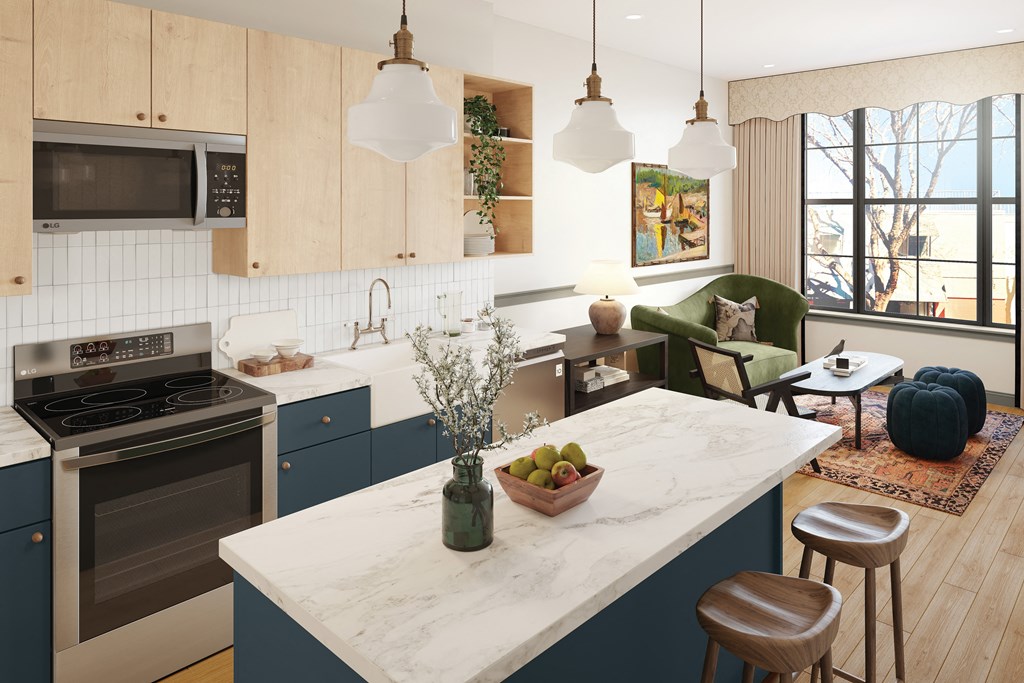 a kitchen with blue cabinets and a marble counter top