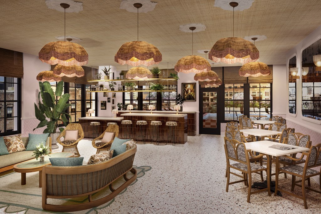 the lobby of a restaurant with rattan chairs and tables