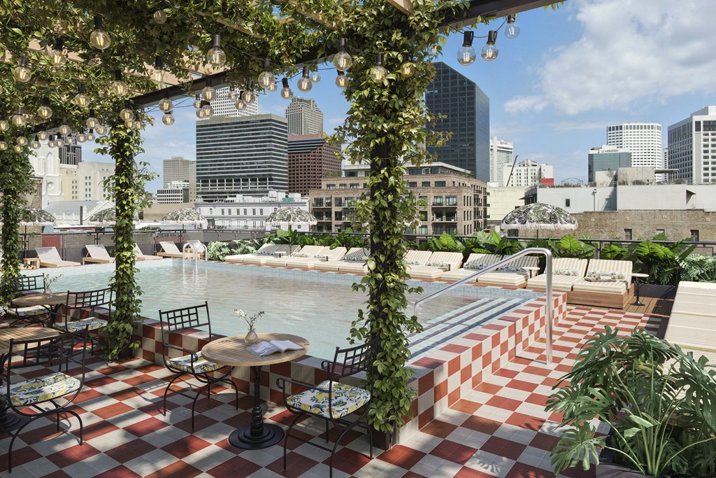 a view of a pool with a city skyline in the background