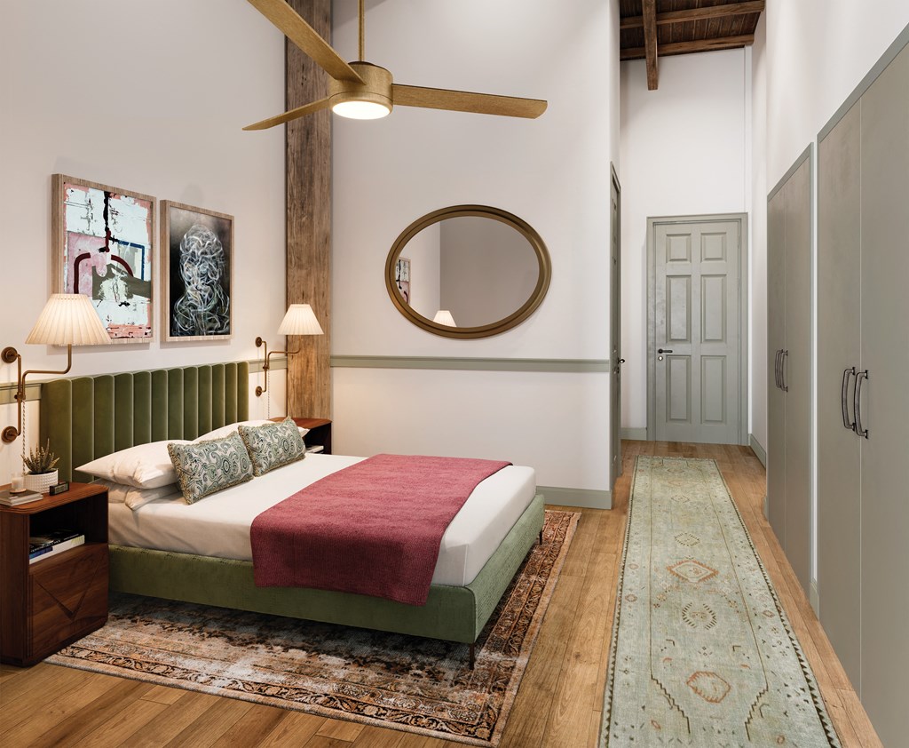 a bedroom with a bed and a round mirror