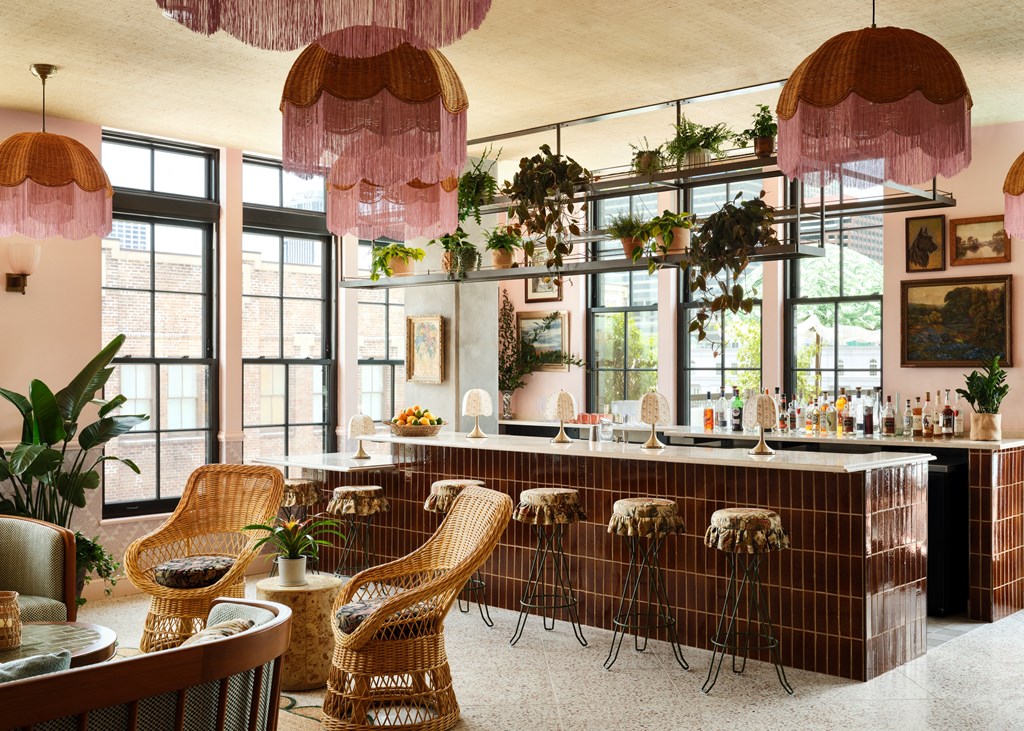 a bar with chairs and a counter in a room with windows