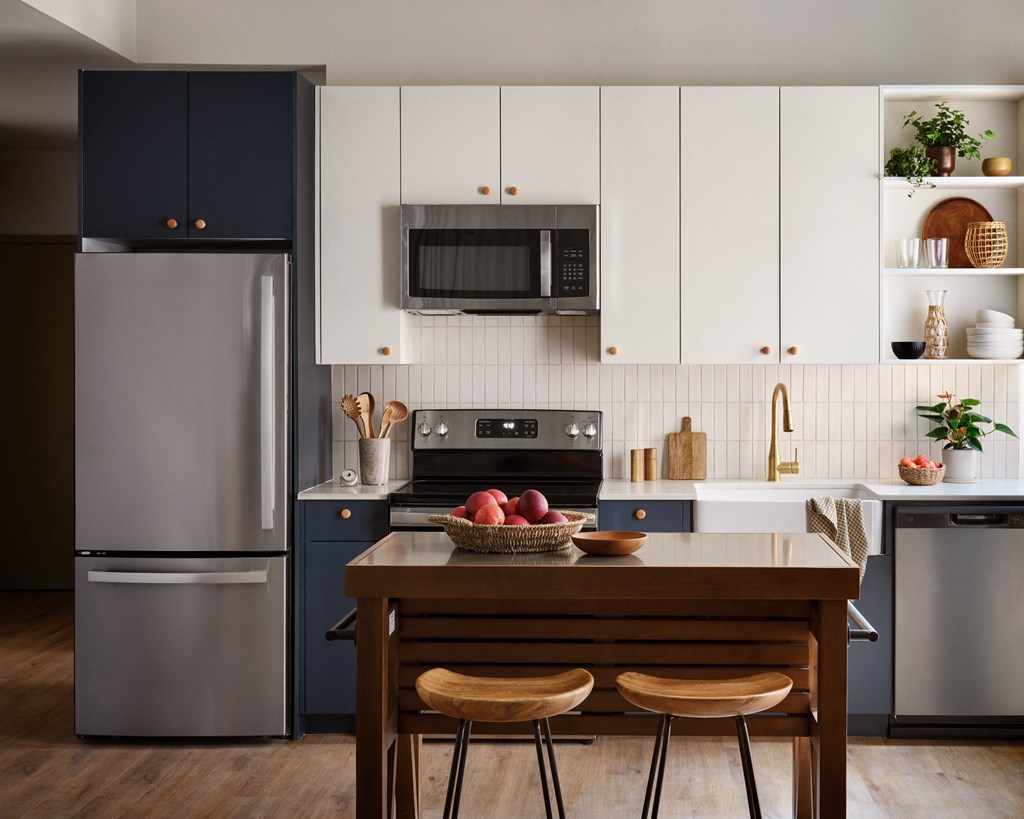 a kitchen with stainless steel appliances and a wooden table