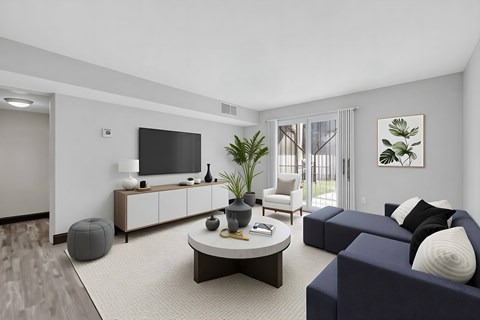 A living room with a blue couch and a white coffee table.