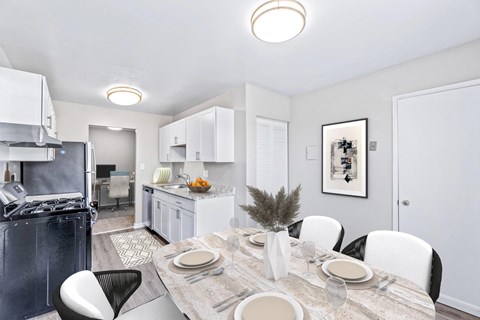 A modern kitchen with a dining table set for four.