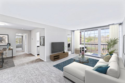 A living room with a white couch and a television.