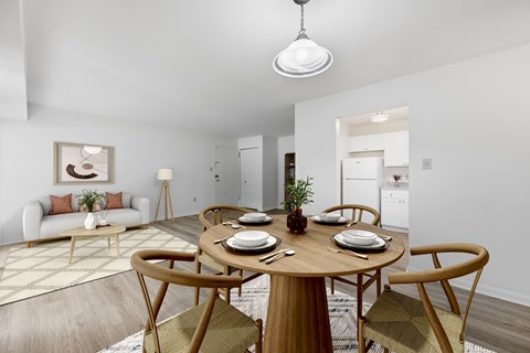 A dining room with a round table set for four.