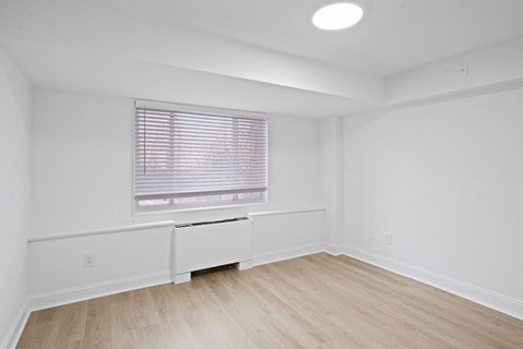 Bedroom with vinyl plank flooring.