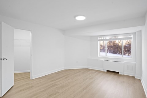 Bedroom with vinyl plank flooring.