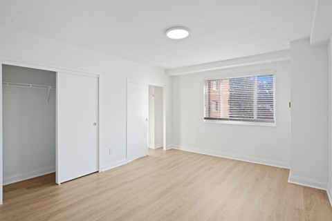 Bedroom with vinyl plank flooring.