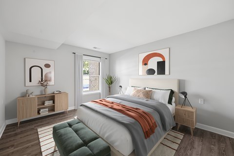 A bedroom with a large bed and a green bench.