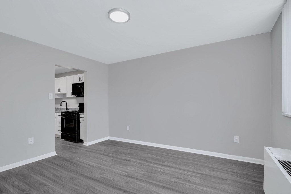Renovated dining room and kitchen. Grey plank flooring.