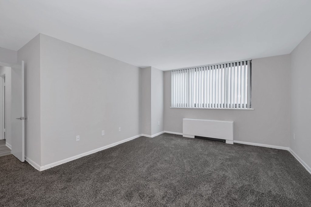 Renovated bedroom with grey carpeting.