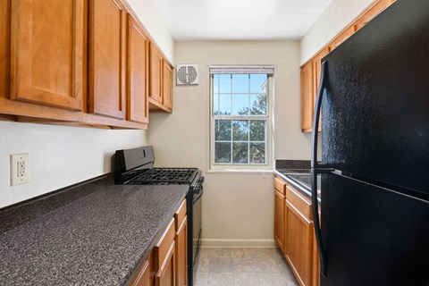 a kitchen with black appliances and granite counter tops