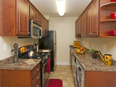 a kitchen with stainless steel appliances and granite counter tops