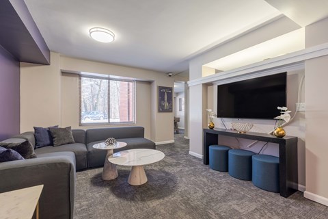 A living room with grey sofas and a television.