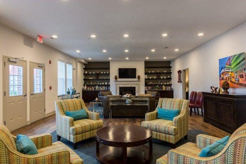a living room with couches and chairs and a fireplace