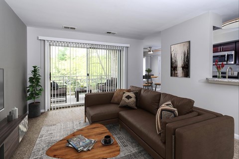 A living room with a brown couch and a coffee table.