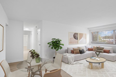 A living room with a glass table and chairs.