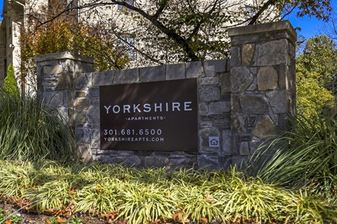 A stone sign that says Yorkshire in front of some plants.