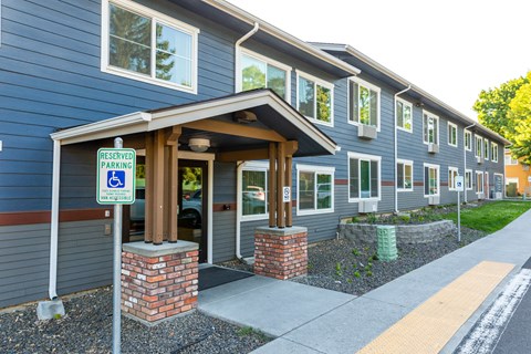 a blue building with a parking sign in front of it