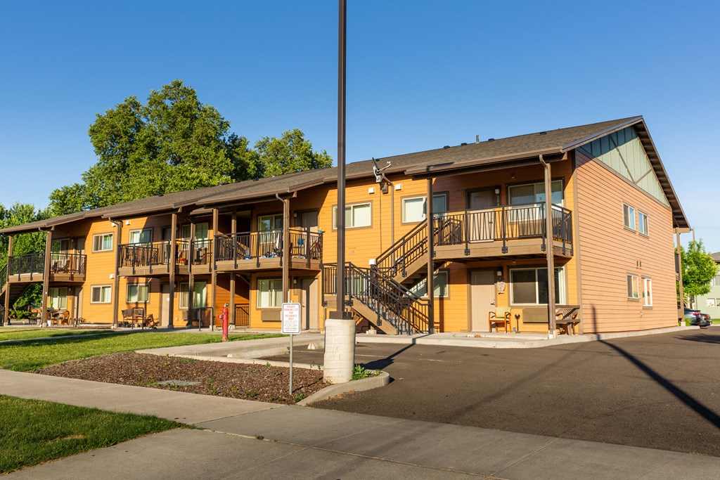 the exterior of an apartment building with balconies and stairs